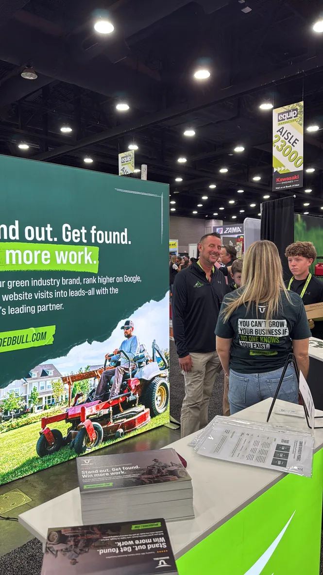 Branded Bull team members talking with attendees at the Equip Expo booth